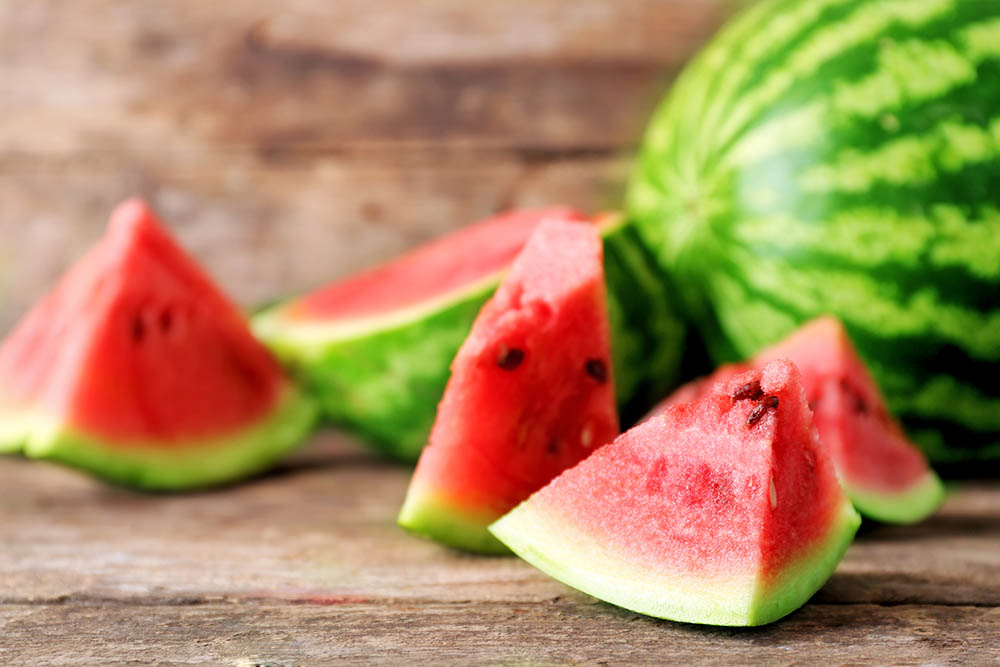 Fresh sliced watermelon wooden background