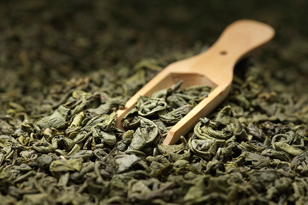 Tea leaves background/ green tea/  wooden scoop/