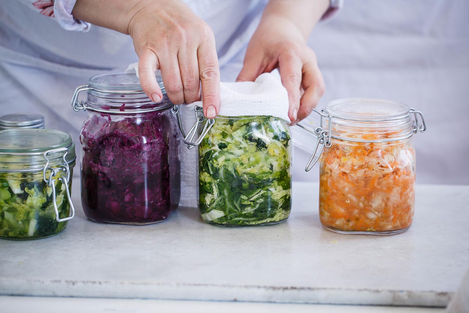 Sauerkraut variety preserving jars. Beetroot kraut, green kraut, yellow kraut in mason jars. Fermentation, probiotic, preserving food concept