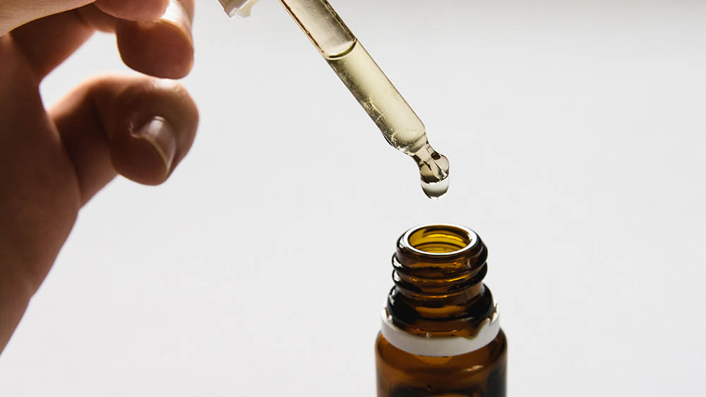 cosmetic product, bottle with hyaluronic acid on a white background, close-up