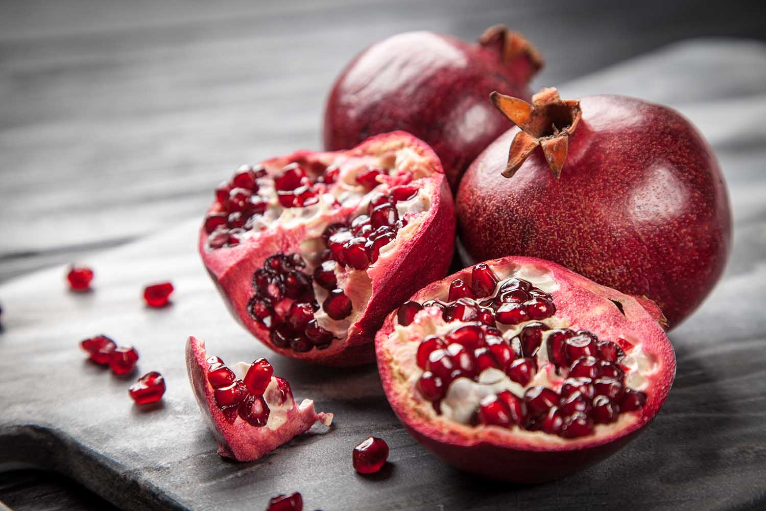 Red juice pomegranate on dark background