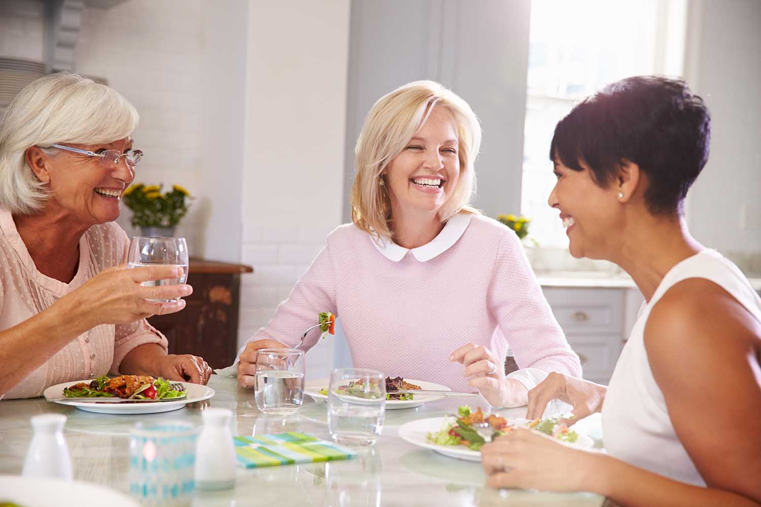 Group Of Mature Female Friends Enjoying Meal At Home