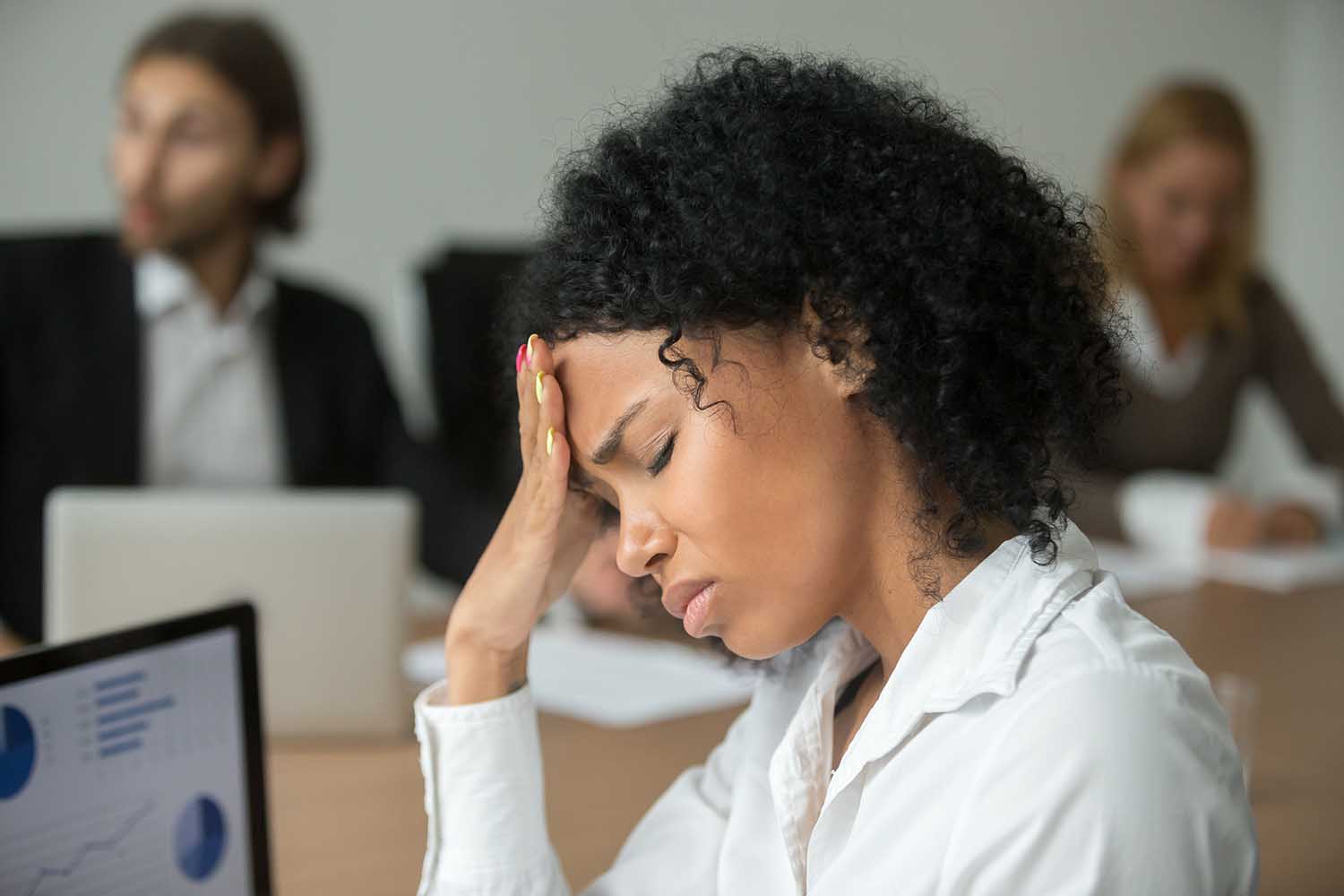 African american businesswoman feeling unwell suffering from headache migraine touching forehead at team meeting, upset black woman employee frustrated by business problem or work stress, head shot