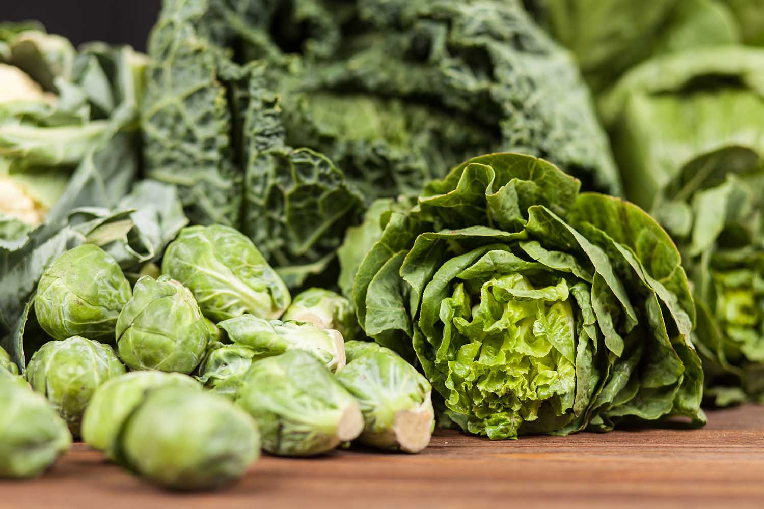 Assortment of green vegetables on wooden surface