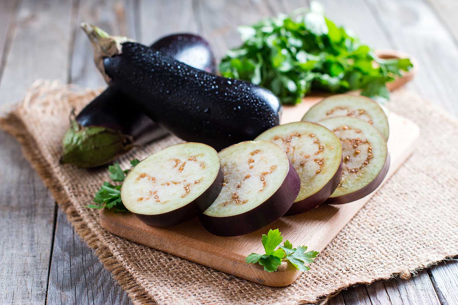 Sliced eggplant on wooden cutting board