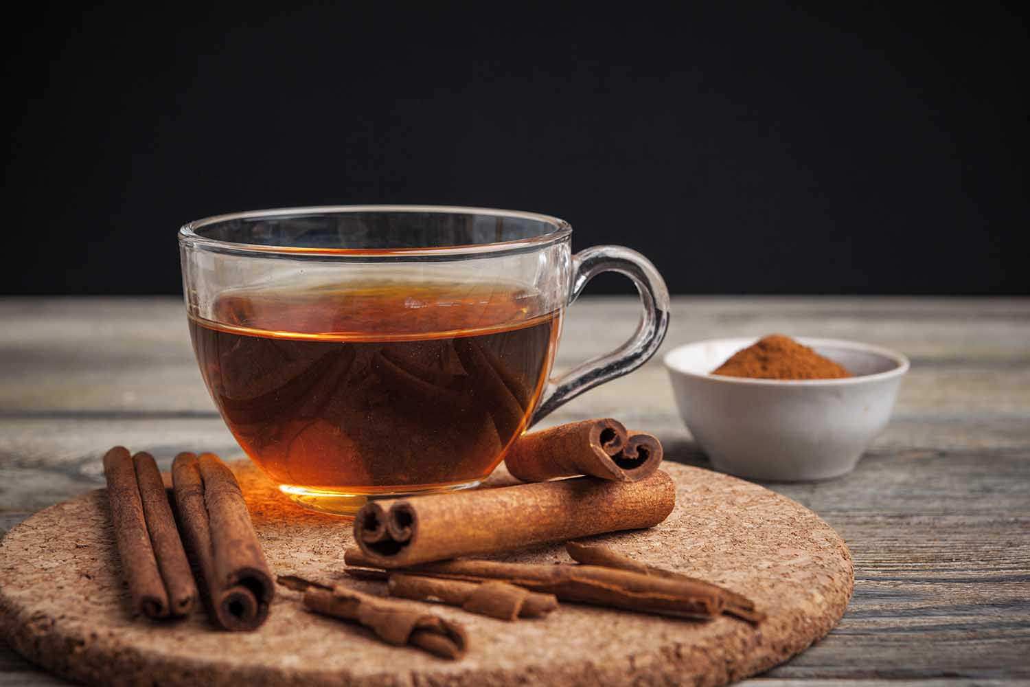 aromatic hot cinnamon tea on wooden table