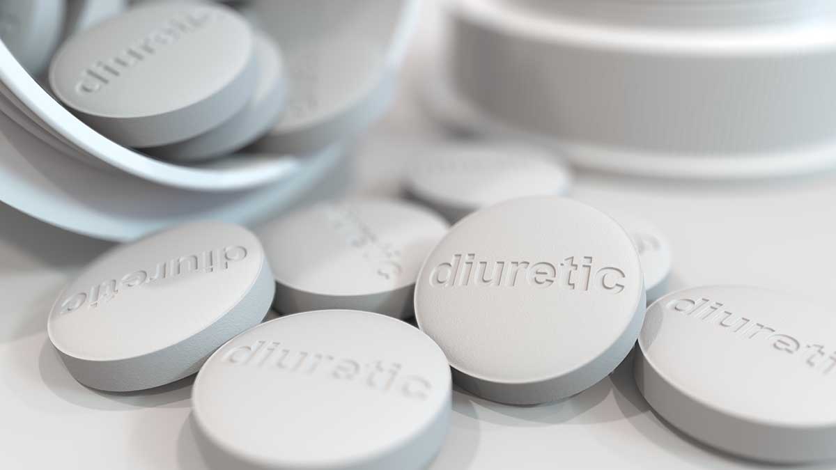 Close-up shot of pills with stamped DIURETIC text on them. 3D rendering