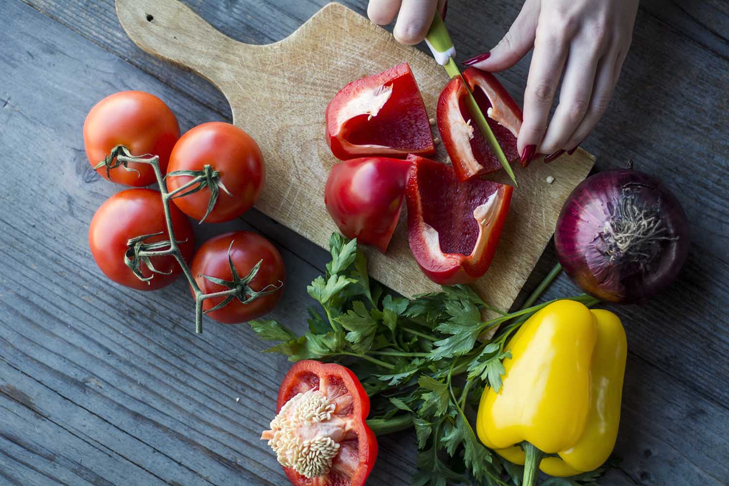 Woman's hand preparing salad