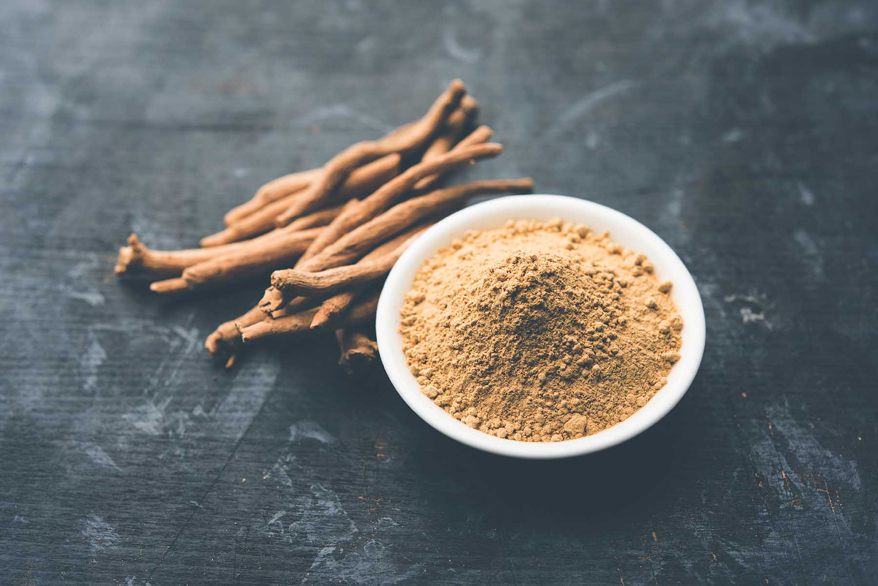 Ashwagandha / Aswaganda OR Indian Ginseng is an Ayurveda medicine in stem and powder form. Isolated on plain background. selective focus