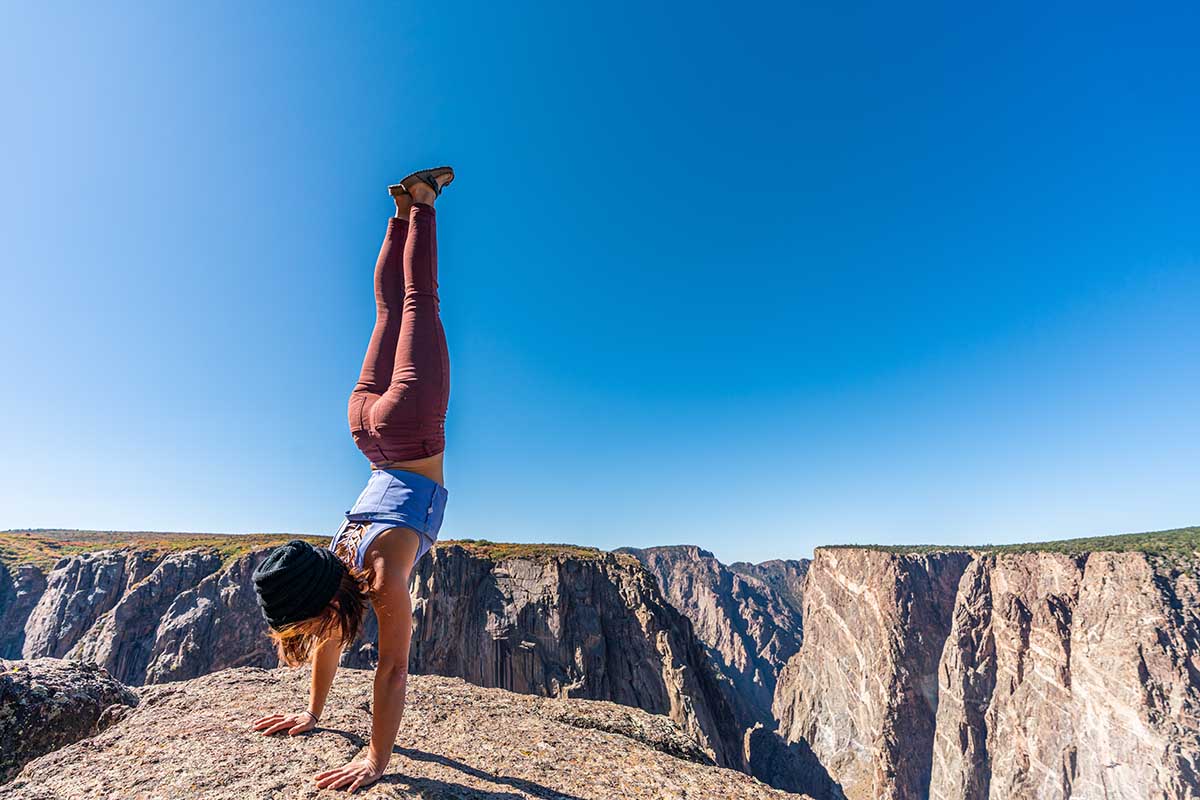 Woman Doing Handstands and Looking Over the Black Canyon of the Gunnison