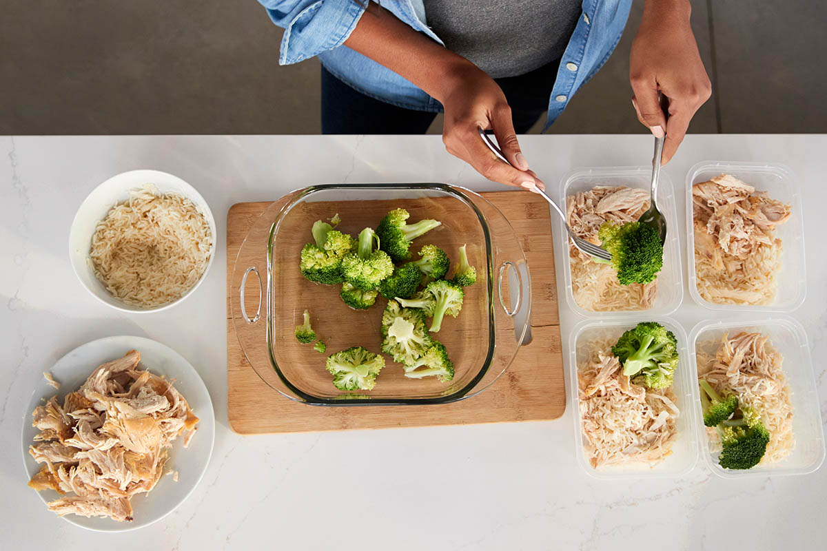 Overhead View Of Woman In Kitchen Preparing High Protein Meal