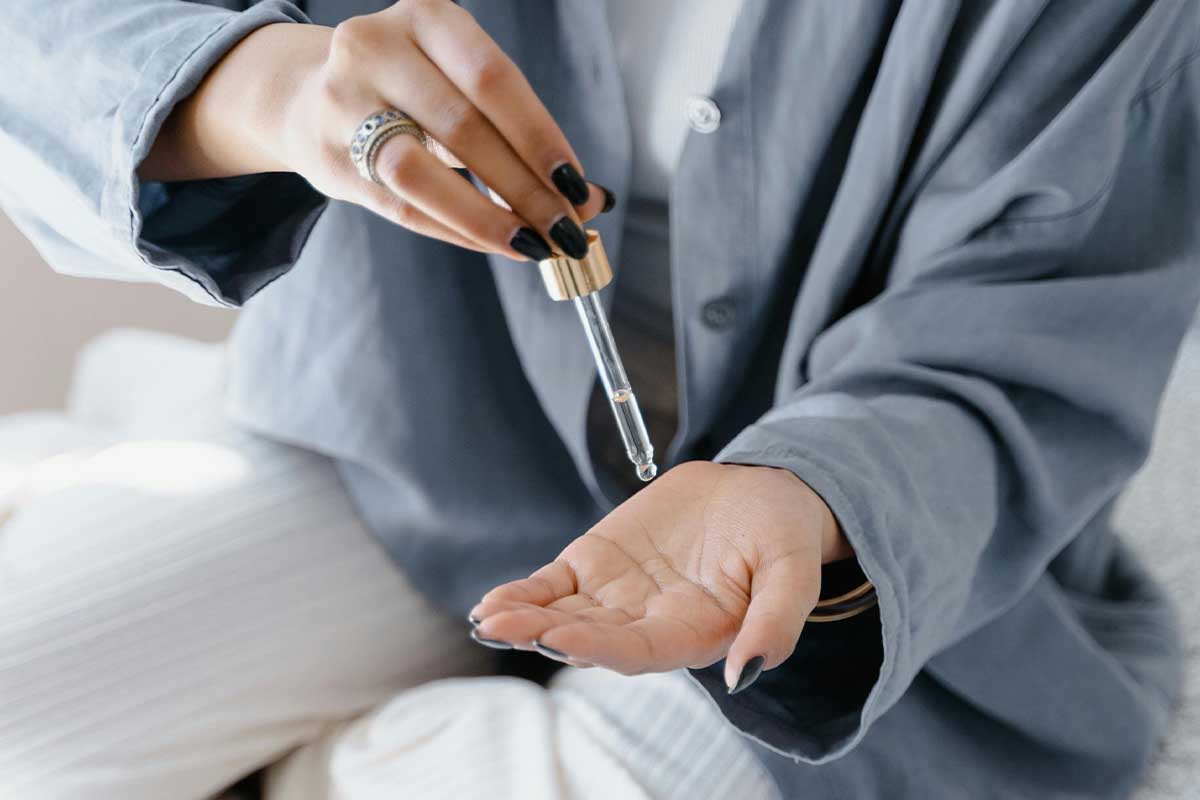 Woman putting oil on her hands