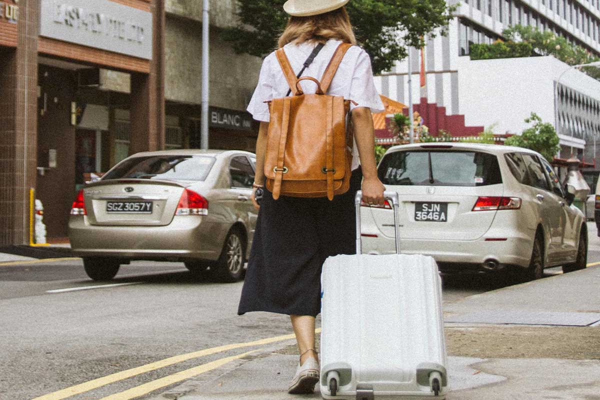 Woman walking and pulling a suitcase