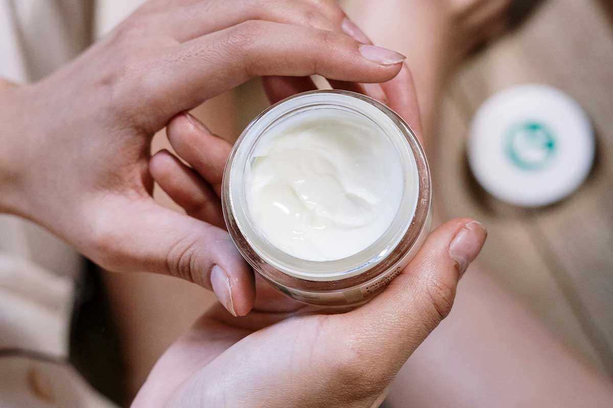 Hands holding skincare product