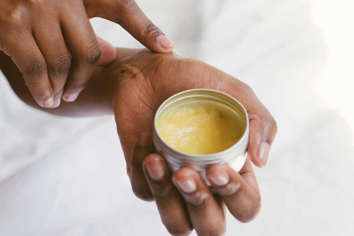 Women putting on skin cream 