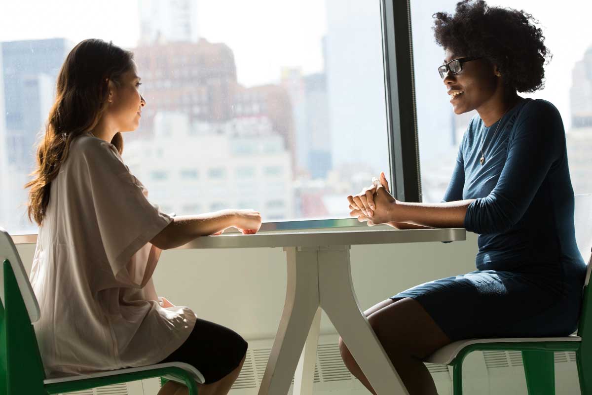 Two people chatting at a table