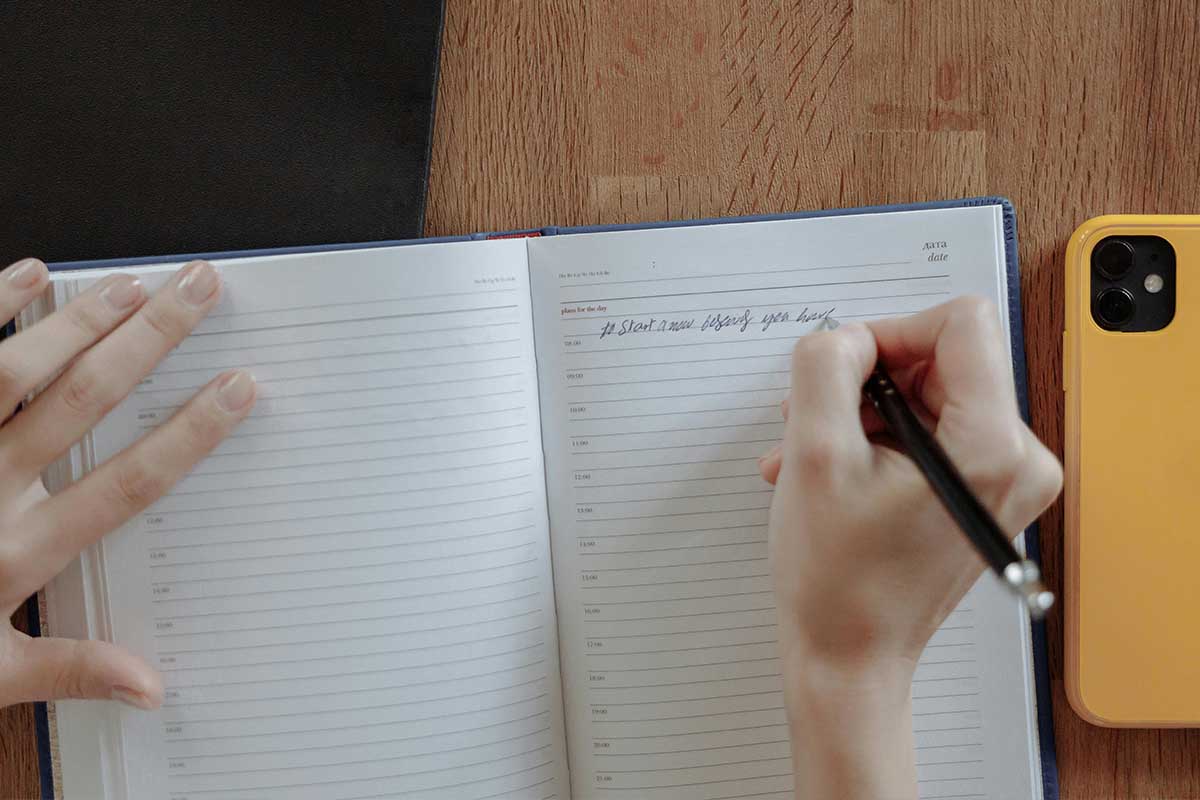 Person writing in notebook